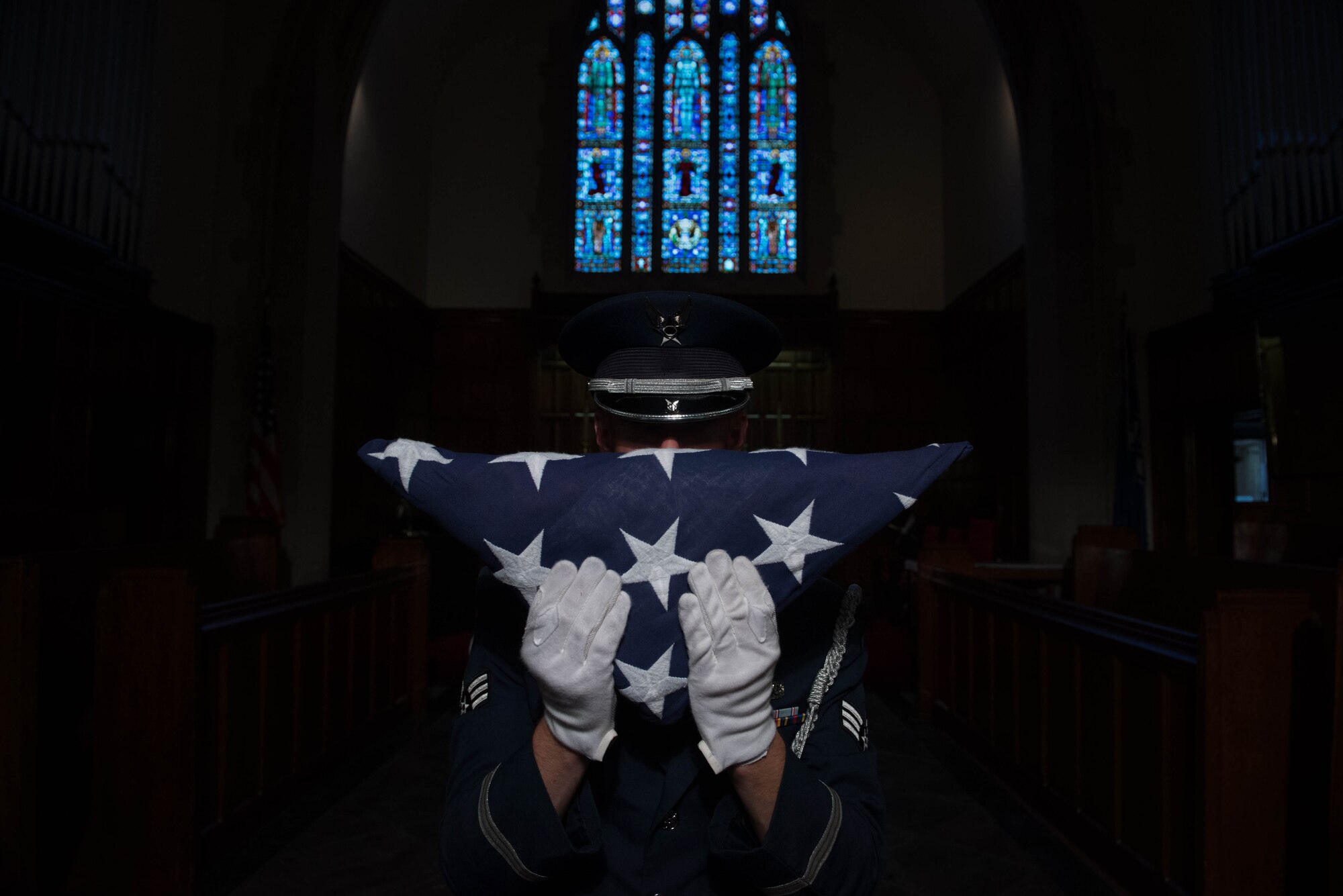 U.S. Air Force Senior Airman Luke Goins, 633rd Force Support Squadron ceremonial honor guardsman, presents the American Flag after a flag folding ceremony at Joint Base Langley-Eustis, Va., June 12, 2017. The ceremony was in honor of Flag Day, which is observed on June 14 every year. (U.S. Air Force photo/Staff Sgt. Carlin Leslie)