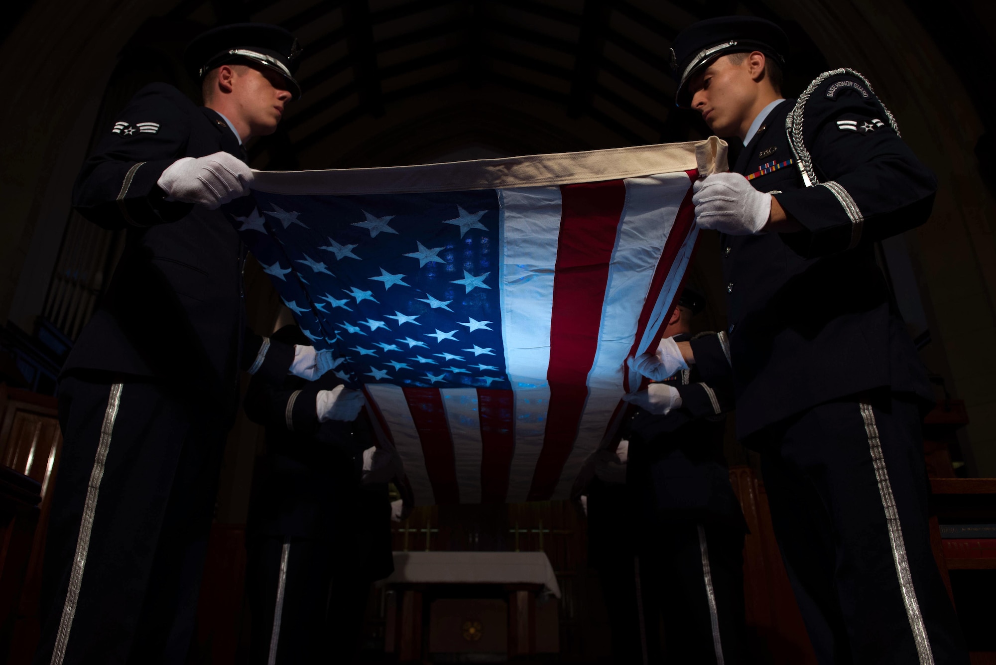 U.S. Air Force service members, assigned to the base Honor Guard, perform a flag folding ceremony at Joint Base Langley-Eustis, Va., June 12, 2017. The flag folding ceremony is a time honored tradition that is used during Memorial Day and Veterans Day ceremonies, as well as retirements from the Armed Forces. (U.S. Air Force photo/ Staff Sgt. Carlin Leslie)