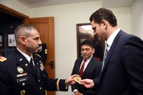 U.S. Army Reserve Lt. Col. Daniel Jaquint, left, Chief of Staff, 85th Support Command, explains the 85th Support Command’s coin to Kenneth Clarke, right, President and Chief Executive Offi-cer, Pritzker Military Museum & Library, at the Pritzker Military Museum & Library in Chicago, June 5, 2017. The coin displays an image of the command’s namesake General George Arm-strong Custer in the center on one side and the command’s iconic green and red “CD” patch on the reverse side. The coin includes the 85th Support Command’s World War II campaign streamers; and the names of the four Soldiers, who were awarded the Medal of Honor during World War II, are etched around the rim of the coin. The 85th Support Command’s lineage began as the 85th Infantry Division at Camp Custer, Michigan, where the division was nicknamed the “Custer Division,” on Aug. 5, 1917. The Division was deactivated in 1945 following World War II, then later reactivated in Chicago on February 19, 1947 in the U.S. Army Reserve as a training division. The 85th Spt. Cmd. is celebrating its centennial anniversary this year.
(U.S. Army Photo by Sgt. Aaron Berogan/Released)