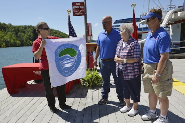 Diane Parks, chief of operations, U.S. Army Corps of Engineers, Nashville District, presents the “Clean marina” flag certifying  “Clean Marina” status on Dale Hollow Lake in Burkesville, Ky., to (L to R) Frank, Pat and Patty Brendel for their work in taking the initiative to achieve “Clean Marina” status.  The Hendricks Creek Marina on Dale Hollow Lake raised the “Clean  Marina” flag today during a dedication ceremony recognizing the marina’s voluntary efforts to reduce water pollution and erosion in the Cumberland River watershed, and for promoting environmentally responsible marina and boating practices.