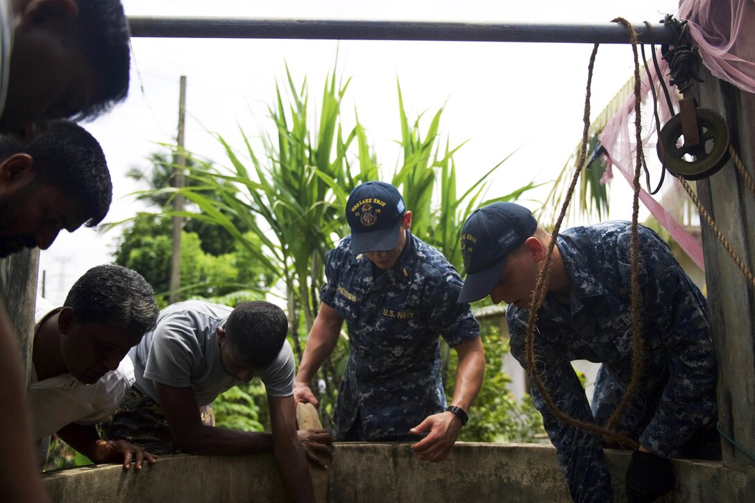 American sailors assigned to the Ticonderoga-class guided missile cruiser USS Lake Erie work with Sri Lankans to pump water to support humanitarian assistance operations in the wake of severe flooding and landslides that devastated many regions of the country in Colombo, Sri Lanka, June 12, 2017. Navy photo by Petty Officer 3rd Class Lucas T. Hans