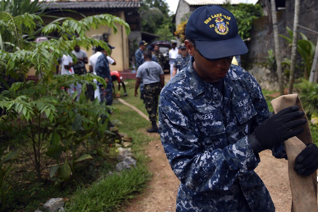 Navy Petty Officer 3rd Class James Burgess, assigned to the Ticonderoga-class guided missile cruiser USS Lake Erie, wraps a water pump hose after emptying a well to support humanitarian assistance operations in Sri Lanka in the wake of severe flooding and landslides that devastated many regions of the country in Colombo, Sri Lanka, Jun, 12, 2017. Recent heavy rainfall brought by a southwest monsoon triggered flooding and landslides throughout the country, displacing thousands of people and causing significant damage to homes and buildings. Navy photo by Petty Officer 3rd Class Lucas T. Hans