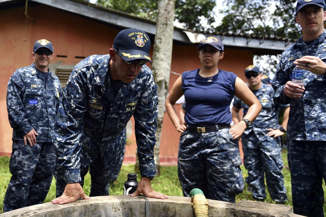 Navy Capt. Darren McPherson, commanding officer of the Ticonderoga-class guided missile cruiser USS Lake Erie, and his crew work with Sri Lankans to pump water to support humanitarian assistance operations in the wake of severe flooding and landslides that devastated many regions of the country in Colombo, Sri Lanka, June 12, 2017. Navy photo by Petty Officer 3rd Class Lucas T. Hans