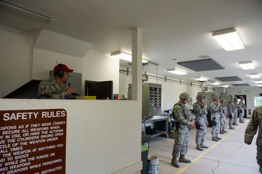 U.S. Air Force Staff Sgt. Gregory Chmielewski, a 354th Security Forces Squadron combat arms instructor, instructs Airmen where to shoot targets June 7, 2017, at Eielson Air Force Base, Alaska. In his spare time, Chmielewski raises and trains sprint dogs. (U.S. Air Force photo by Airman 1st Class Isaac Jonson)