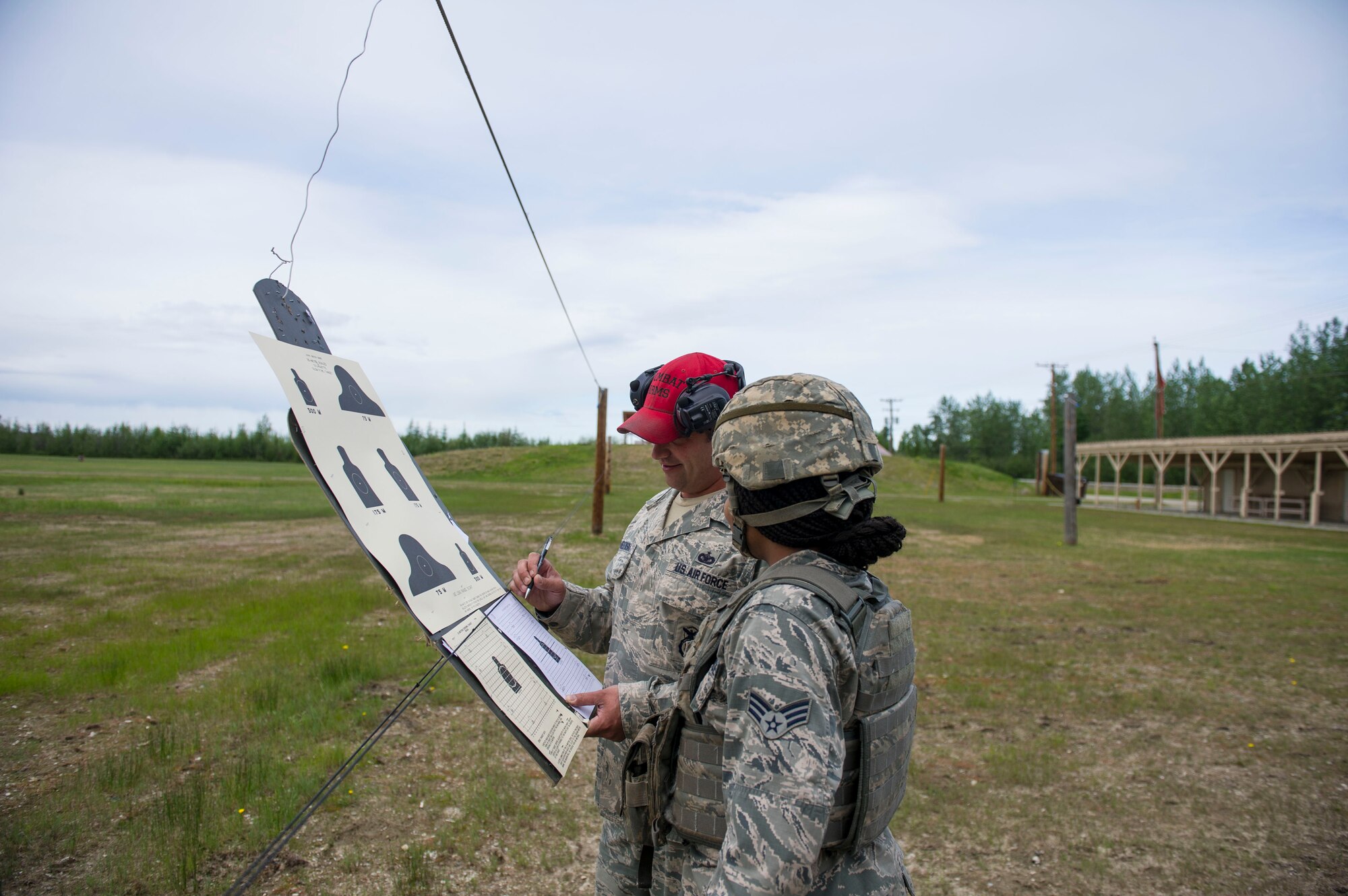 U.S. Air Force Staff Sgt. Gregory Chmielewski, a 354th Security Forces Squadron (SFS) combat arms instructor, helps an SFS Airman site their rifle June 7, 2017, at Eielson Air Force Base, Alaska. Chmielewski and the Combat Arms Training and Maintenance team qualify around 1,100 people every year, and are on schedule to train even more in 2017. (U.S. Air Force photo by Airman 1st Class Isaac Jonson)

