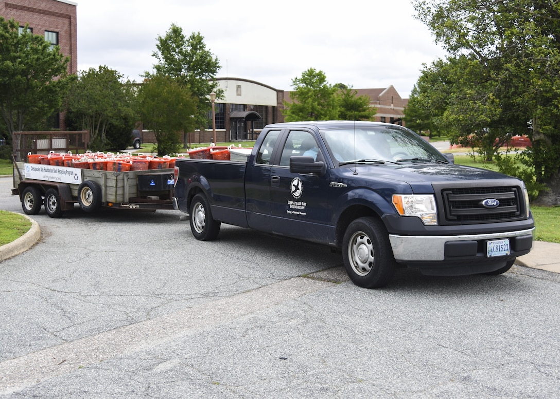 The Chesapeake Bay Foundation drops-off 75 bushels of recycled oyster shells for an environmental restoration event at Joint Base Langley-Eustis, Va., June 8, 2017. During the event, students of Booker Elementary School placed oyster shells near the Langley Air Force Base marina so that approximately 2,000 young oysters could attach to them and build a new ecosystem. (U.S. Air Force photo/Airman 1st Class Anthony Nin Leclerec)