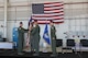 388th Fighter Wing Operations Group commander Col. Jason Rueschhoff hands the 4th Fighter Squadron guidon to new 4th Fighter Squadron commander Lt. Col. Yosef Morris at a ceremony June 9 at Hill Air Force Base as former commander Lt. Col. Steven Engberg stands at attention.