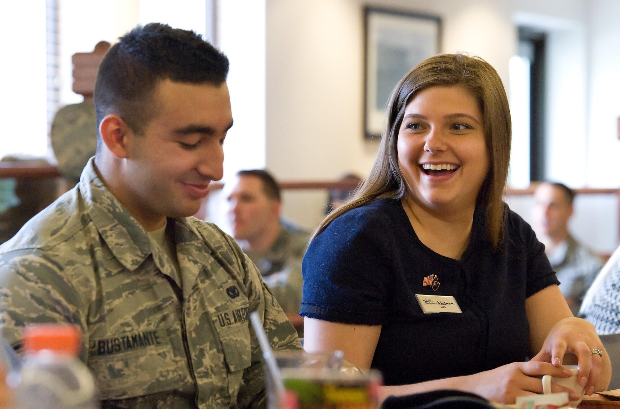 Melissa Dravis, United Parcel Service human resources supervisor out of Seattle, Wash., and Airman Alfonso Bustamante, 436th Security Forces Squadron response force member, share a funny moment during breakfast June 8, 2017 at the Patterson Dining Facility on Dover Air Force Base, Del. Honorary commanders, civic leaders and 62nd Airlift Wing senior leadership from Joint Base Lewis-McChord, Wash., got to meet with Team Dover Airmen before starting day two of their Community Relations Tour. (U.S. Air Force photo by Roland Balik)