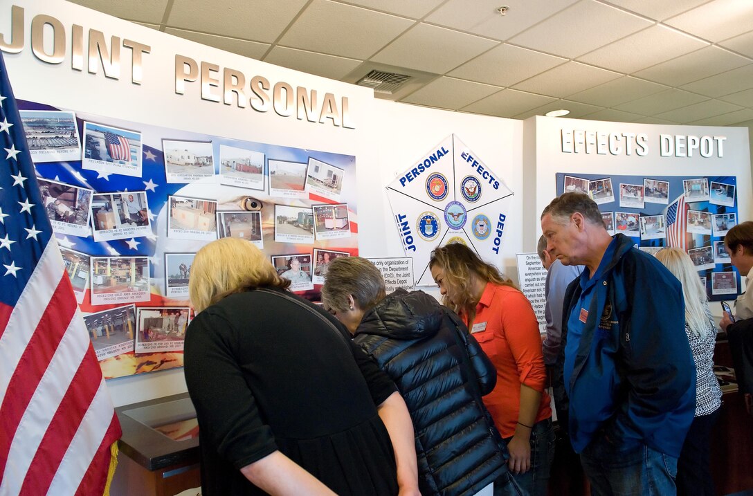 Joint Base Lewis-McChord, Wash., honorary commanders and civic leaders look at display cases June 8, 2017 at the Joint Personal Effects Depot on Dover Air Force Base, Del. The display cases contained unclaimed items recovered at the Pentagon from the 9/11 attack. (U.S. Air Force photo by Roland Balik)