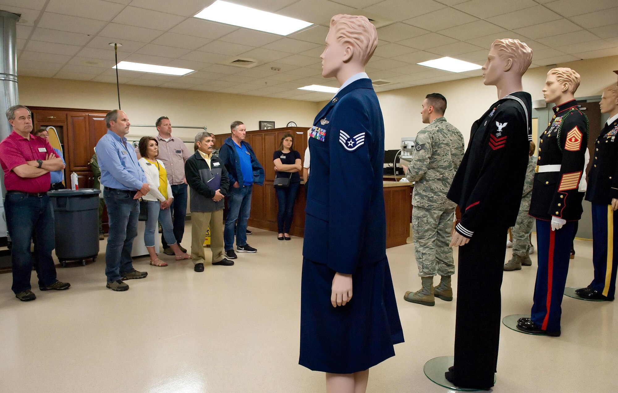 Staff Sgt. Guiseppe Francioni, Air Force Mortuary Affairs Operations uniform section, briefs Joint Base Lewis-McChord, Wash., honorary commanders and civic leaders about all the service uniforms carried in the section for fallen service members June 8, 2017, at AFMAO on Dover Air Force Base, Del. Francioni mentioned that fallen service members are provided brand-new dress uniforms with all the proper decorations and medals prior to departing AFMAO. (U.S. Air Force photo by Roland Balik)