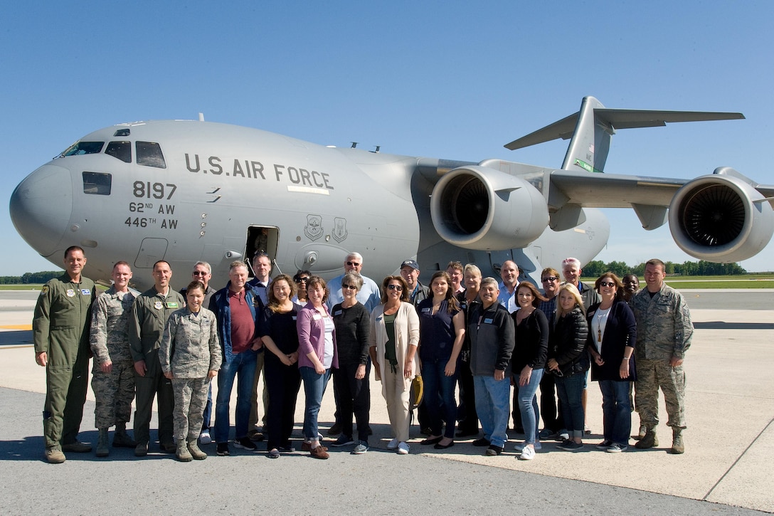 Senior leadership from the 43th Airlift Wing and 62nd AW, along with Joint Base Lewis-McChord, Wash., honorary commanders and civic leaders, pose for a photo in front of a C-17A Globemaster III, June 9, 2017, on Dover Air Force Base, Del. The JBLM group came to Dover for a three-day Community Relations Tour. (U.S. Air Force photo by Roland Balik)