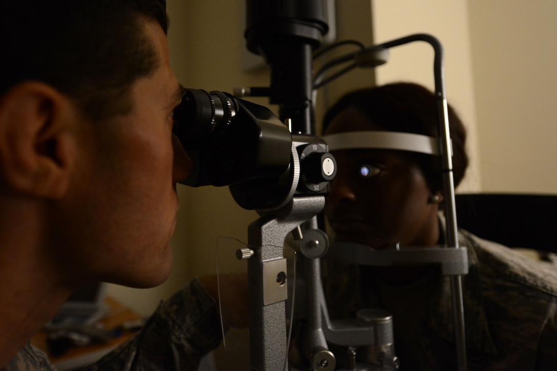 U.S. Air Force Capt. John Kauderman, 20th Aerospace Medicine Squadron optometrist, uses a slit lamp to examine a patient’s eye at Shaw Air Force Base, S.C., June 14, 2017. Kauderman used the instrument, which magnifies and directs light into the eye, to evaluate for disease or abnormality. (U.S. Air Force photo by Airman 1st Class Kathryn R.C. Reaves)