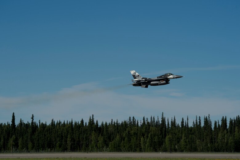A U.S. Air Force F-16 Aggressor takes off from the flight line during RED FLAG-Alaska 17-2 June 13, 2017, at Eielson Air Base, Alaska. RED FLAG-Alaska provides an optimal training environment in the Indo-Asia Pacific Region and focuses on improving ground, space, and cyberspace combat readiness and interoperabillity for U.S. and international forces.  (U.S. Air Force photo by Airman 1st Class Haley D. Phillips)