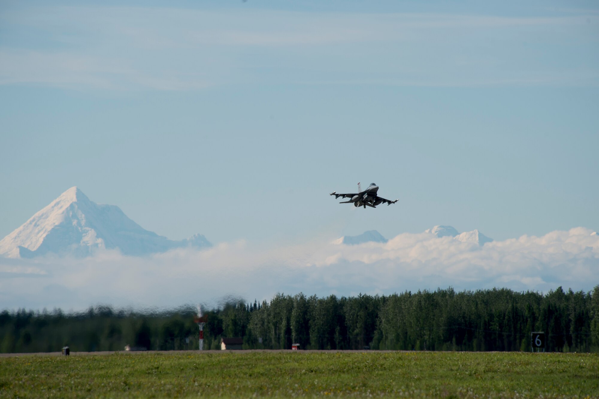 A U.S. Air Force F-16 Aggressor takes off from the flight line during RED FLAG-Alaska 17-2 June 13, 2017, at Eielson Air Base, Alaska. RED FLAG-Alaska provides an optimal training environment in the Indo-Asia Pacific Region and focuses on improving ground, space, and cyberspace combat readiness and interoperabillity for U.S. and international forces.  (U.S. Air Force photo by Airman 1st Class Haley D. Phillips)