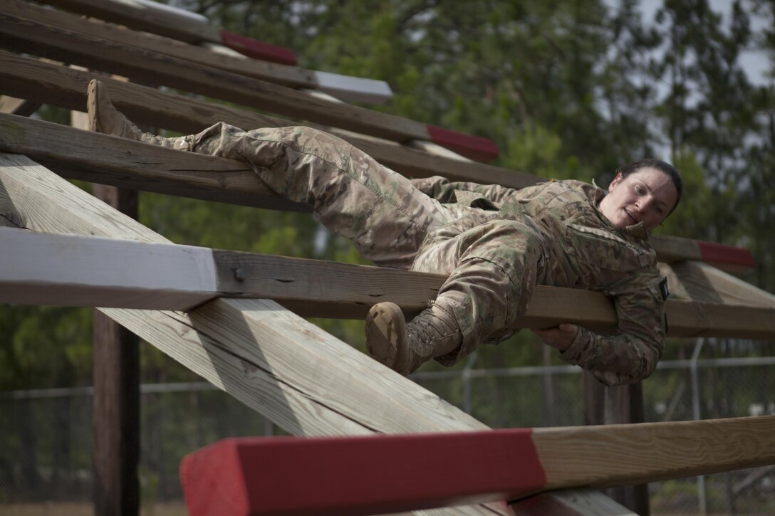 Sgt. Erin Hodge, a preventive medicine specialist with the 7th Mission Support Command, Kaiserslautern, Germany, weaves through wooden beams, as part of the 2017 U.S. Army Reserve Best Warrior Competition, Fort Bragg, N.C., June 13, 2017. Competitors must try to complete as many obstacles as they can, as fast as they can. The obstacle course is only one event in the entire competition. This year’s Best Warrior Competition will determine the top noncommissioned officer and junior enlisted Soldier who will represent the U.S. Army Reserve in the Department of the Army Best Warrior Competition later this year at Fort A.P. Hill, Va. (U.S. Army Reserve photo by Spc. Milcah Villaronga) (Released)