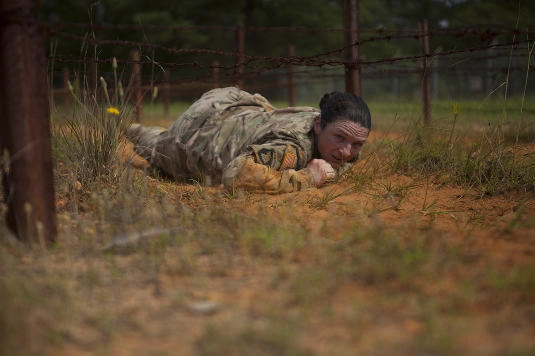 Sgt. Erin Hodge, a preventive medicine specialist with the 7th Mission Support Command, Kaiserslautern, Germany, low-crawls under barbed wire as part of the 2017 U.S. Army Reserve Best Warrior Competition, Fort Bragg, N.C., June 13, 2017. Competitors must try to complete as many obstacles as they can, as fast as they can. The obstacle course is only one event in the entire competition. This year’s Best Warrior Competition will determine the top noncommissioned officer and junior enlisted Soldier who will represent the U.S. Army Reserve in the Department of the Army Best Warrior Competition later this year at Fort A.P. Hill, Va. (U.S. Army Reserve photo by Spc. Milcah Villaronga) (Released)