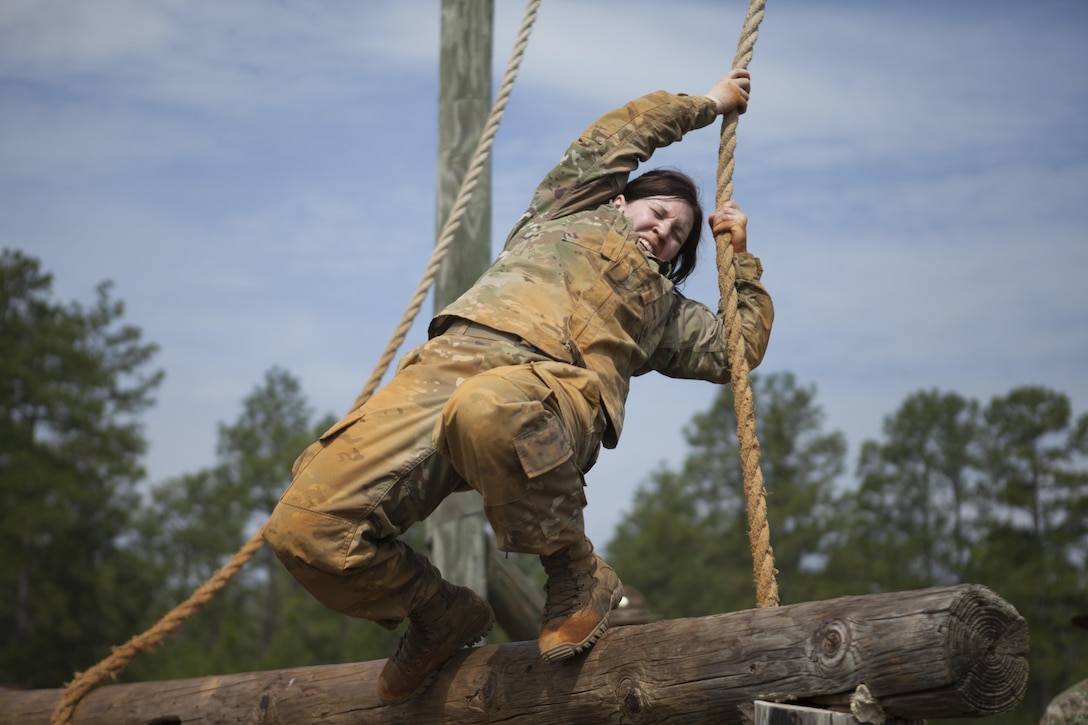 Staff Sgt. Marcy DiOssi, a bridge crewmember-instructor with the 80th Training Command (The Army School System), swings onto a wooden beam as part of the 2017 U.S. Army Reserve Best Warrior Competition, Fort Bragg, N.C., June 13, 2017. Competitors must try to complete as many obstacles as they can, as fast as they can. The obstacle course is only one event in the entire competition. This year’s Best Warrior Competition will determine the top noncommissioned officer and junior enlisted Soldier who will represent the U.S. Army Reserve in the Department of the Army Best Warrior Competition later this year at Fort A.P. Hill, Va. (U.S. Army Reserve photo by Spc. Milcah Villaronga) (Released)