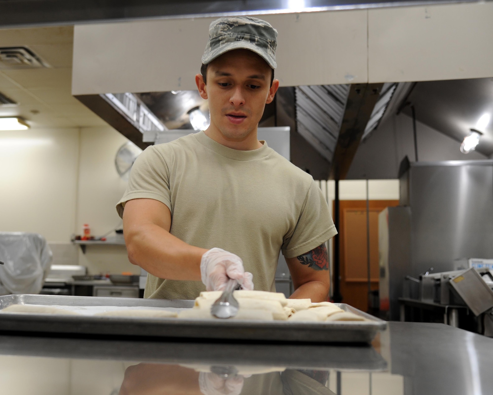 U.S. Air Force Senior Airman Mathew Sanchez, services technician, 927th Air Refueling Wing, MacDill Air Force Base, Florida, prepares to serve breakfast burritos. Sanchez filled a critical role in feeding more than 140 medical and support personnel that participated the Ozark Highlands Innovated Readiness Training, Mountain Home, Arkansas, 5-12 June, a mission that provided no-cost medical care to a local community. (U.S. Air Force photo by Tech. Sgt. Peter Dean)   