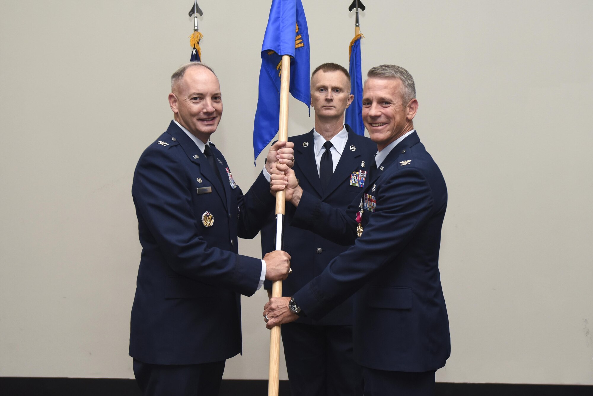 U.S. Air Force Col. Steven Van De Walle, 17th Medical Group Commander, passes the unit guideon to Col. Michael Downs, 17th Training Wing Commander, during the 17th MDG Change of Command ceremony at the Event Center on Goodfellow Air Force Base, Texas, June 13, 2017. The event honored Van De Walle’s service to his unit and welcomed its new commander Col. Janet Urbanski. (U.S. Air Force photo by Airman 1st Class Chase Sousa/Released)