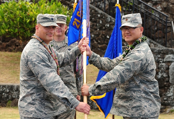 Lt. Col. Phillip Verroco, 21st Space Operations Squadron commander, gives the detachment flag to Maj. Edmond Chan, Detachment 3 incoming commander, during the Detachment 3 Change of Command Ceremony, Kaena Point, Hawaii, June 9, 2017.  Detachment 3 is a component of the 21st Space Operations Squadron, 50th Network Operations Group, 50th Space Wing, and is located on the western tip of Oahu.  It is the oldest and one of seven worldwide remote tracking stations in the Air Force Satellite Control Network.  (U.S. Air Force photo by Tech. Sgt. Heather Redman)