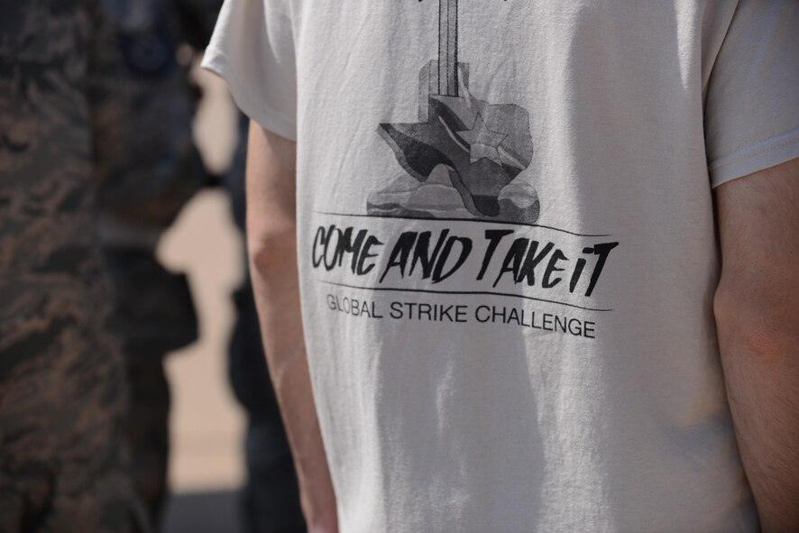 U.S. Air Force Airmen attending the 2017 Global Strike Challenge wear shirts supporting the event on the flightline at Dyess Air Force Base, Texas, June 13, 2017. “Come and Take It,” is a historic slogan, which served as a symbol of Texas independence during the Texas revolution and remains an iconic symbol throughout the state of Texas. (U.S. Air Force photo by Airman 1st Class Katherine Miller)