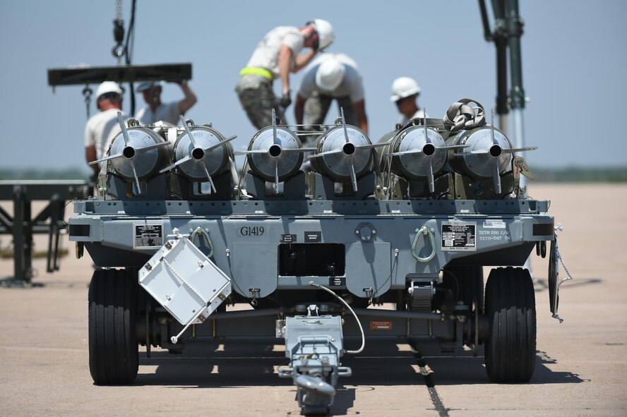 U.S. Air Force Airmen, assigned to the 7th Munitions Squadron, complete a bomb build as the final event in the 2017 Global Strike Challenge at Dyess Air Force Base, Texas, June 13, 2017. During the competition, 7th MUNS crew members built Joint Direct Attack Munitions and manufactured them on a munitions assembly conveyor. (U.S. Air Force photo by Airman 1st Class Emily Copeland)