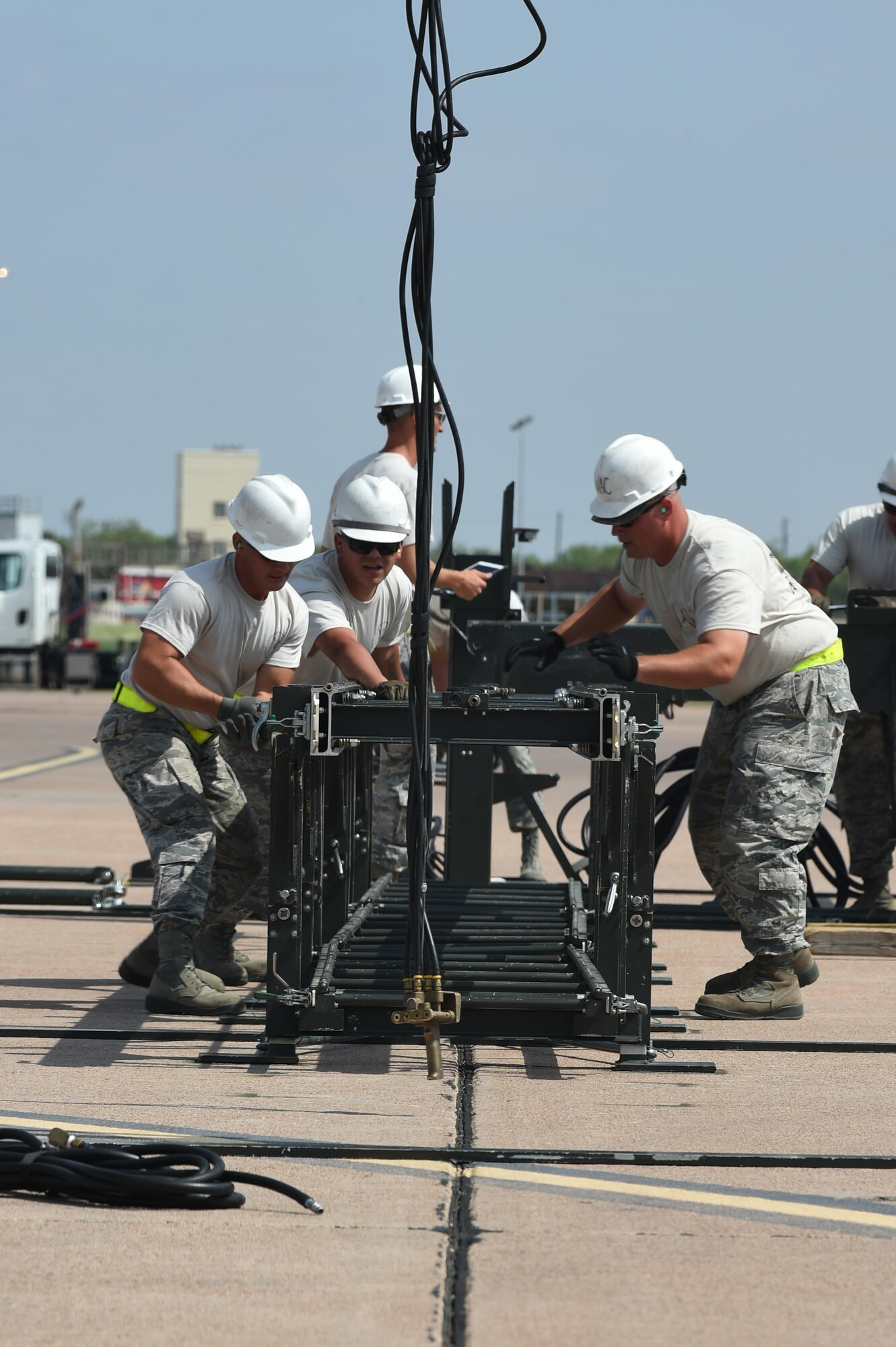 U.S. Air Force Airmen from the 7th Munitions Squadron, construct a munitions assembly conveyor during the 2017 Global Strike Challenge at Dyess Air Force Base, Texas, June 13, 2017. A munitions assembly conveyor is a mobile assembly line used to build bombs efficiently. GSC competitors are selected based upon available wing assets and determined by the unit’s internal competitive team selection process. (U.S. Air Force photo by Airman 1st Class Emily Copeland)