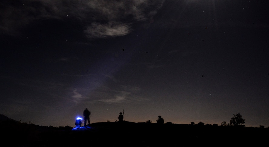 99th Civil Engineer Squadron explosive ordnance team members observe a simulated roadside bomb clearance operation at night during a bivouac exercise at the Nevada Test and Training Range June 7, 2017. Night operations allow EOD team members to practice in a low-visibility environment. (U.S. Air Force photo by Airman 1st Class Andrew D. Sarver/Released)