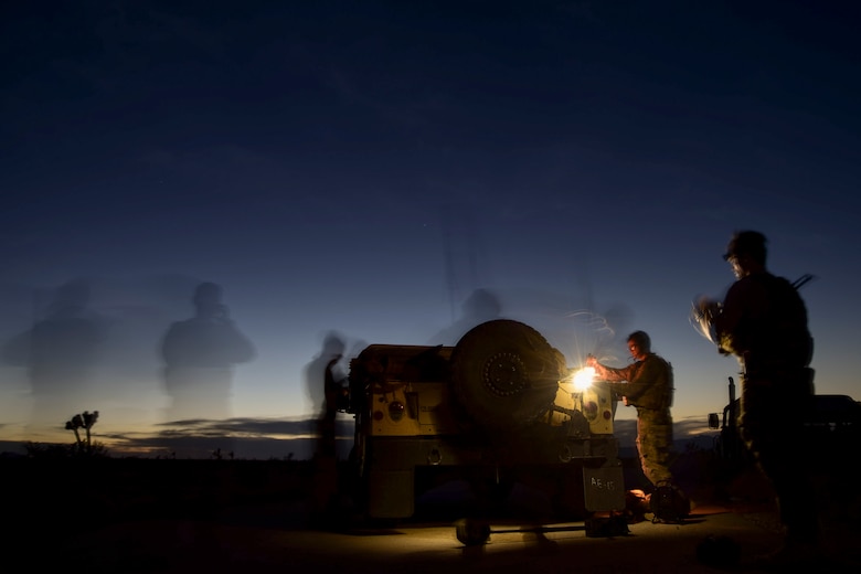 Senior Airman Michael Rodgers, 99th Civil Engineer Squadron explosive ordnance disposal team member, scouts the surrounding area while his team prepares for a night-time simulated roadside bomb clearance operation during a bivouac exercise at the Nevada Test and Training Range June 7, 2017. EOD team members use night vision goggles to help provide them the ability to operate in hours of darkness. (U.S. Air Force photo by Airman 1st Class Andrew D. Sarver/Released)