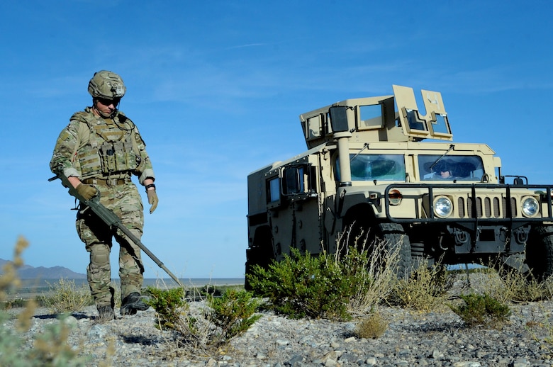 Tech Sgt. Nathaniel Jackson, 99th Civil Engineer Squadron explosive ordnance disposal technician, begins a roadside bomb clearing operation during a training event June 7, 2017 at the Nevada Test and Training Range. The EOD team members were taking part in series of training scenarios designed to test their skills in low-light situations. (U.S. Air Force photo by Senior Airman Joshua Kleinholz)