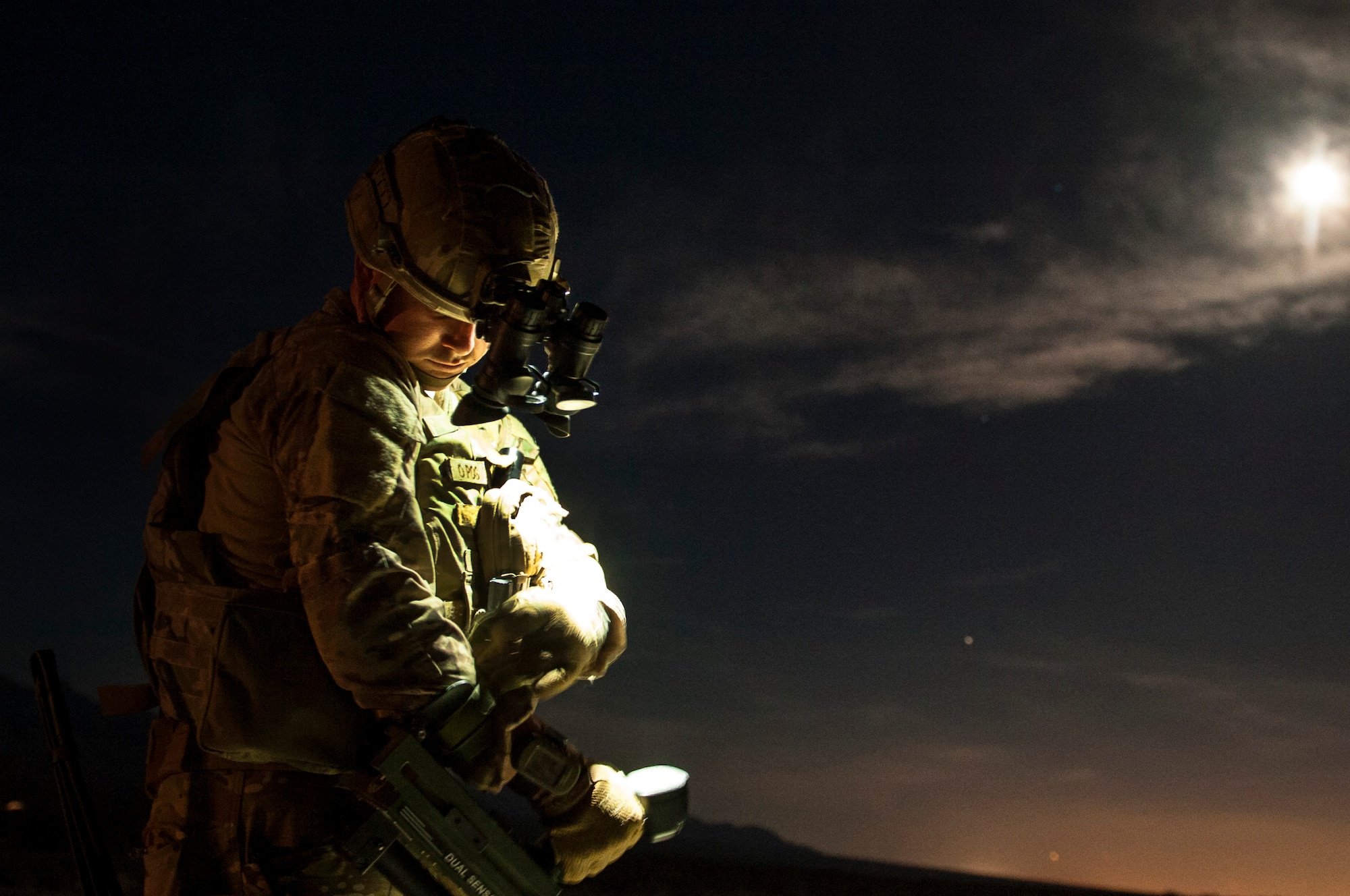 Staff Sgt. Brian Cole, 99th Civil Engineer Squadron explosive ordnance disposal technician, adjusts a metal detector arm strap during a roadside bomb clearing training event, June 7, 2017 on the Nevada Test and Training Range. The overnight exercise tested the team members’ knowledge and resolve; presenting three challenging scenarios over a 12-hour period. (U.S. Air Force photo by Senior Airman Joshua Kleinholz)