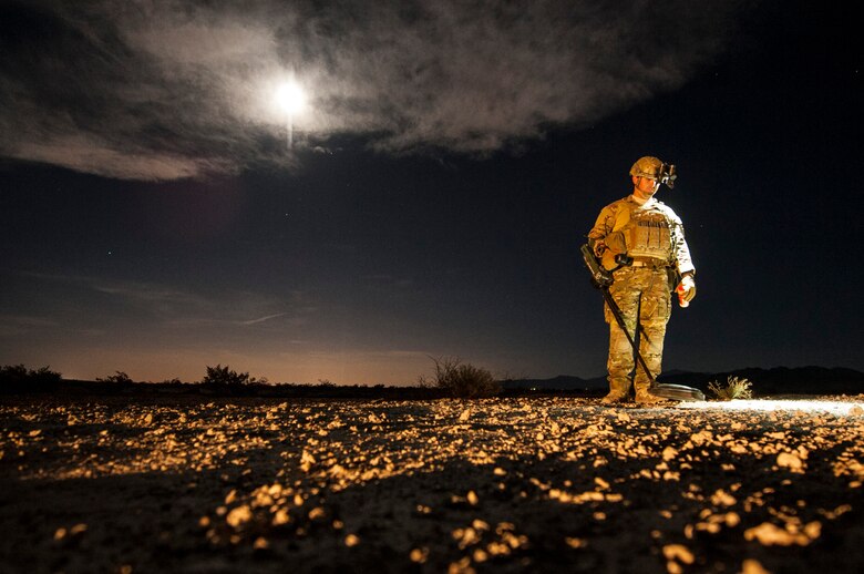 Staff Sgt. Brian Cole, 99th Civil Engineer Squadron explosive ordnance disposal technician, performs a roadside bomb clearing operation during a training event, June 7, 2017 on the Nevada Test and Training Range. Training in low-light conditions ensures that EOD Airmen are ready and able to respond to threats wherever, and whenever, they’re called. (U.S. Air Force photo by Senior Airman Joshua Kleinholz)