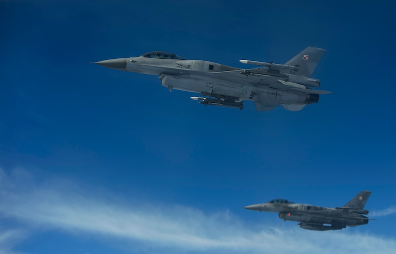 Two Polish air force F-16 Fighting Falcons break away after refueling from a KC-135R Stratotanker during BALTOPS over Latvia, June 14, 2017. The exercise is designed to enhance flexibility and interoperability, to strengthen combined response capabilities, as well as demonstrate resolve among Allied and Partner Nations' forces to ensure stability in, and if necessary defend, the Baltic Sea region. (U.S. Air Force photo by Staff Sgt. Jonathan Snyder)