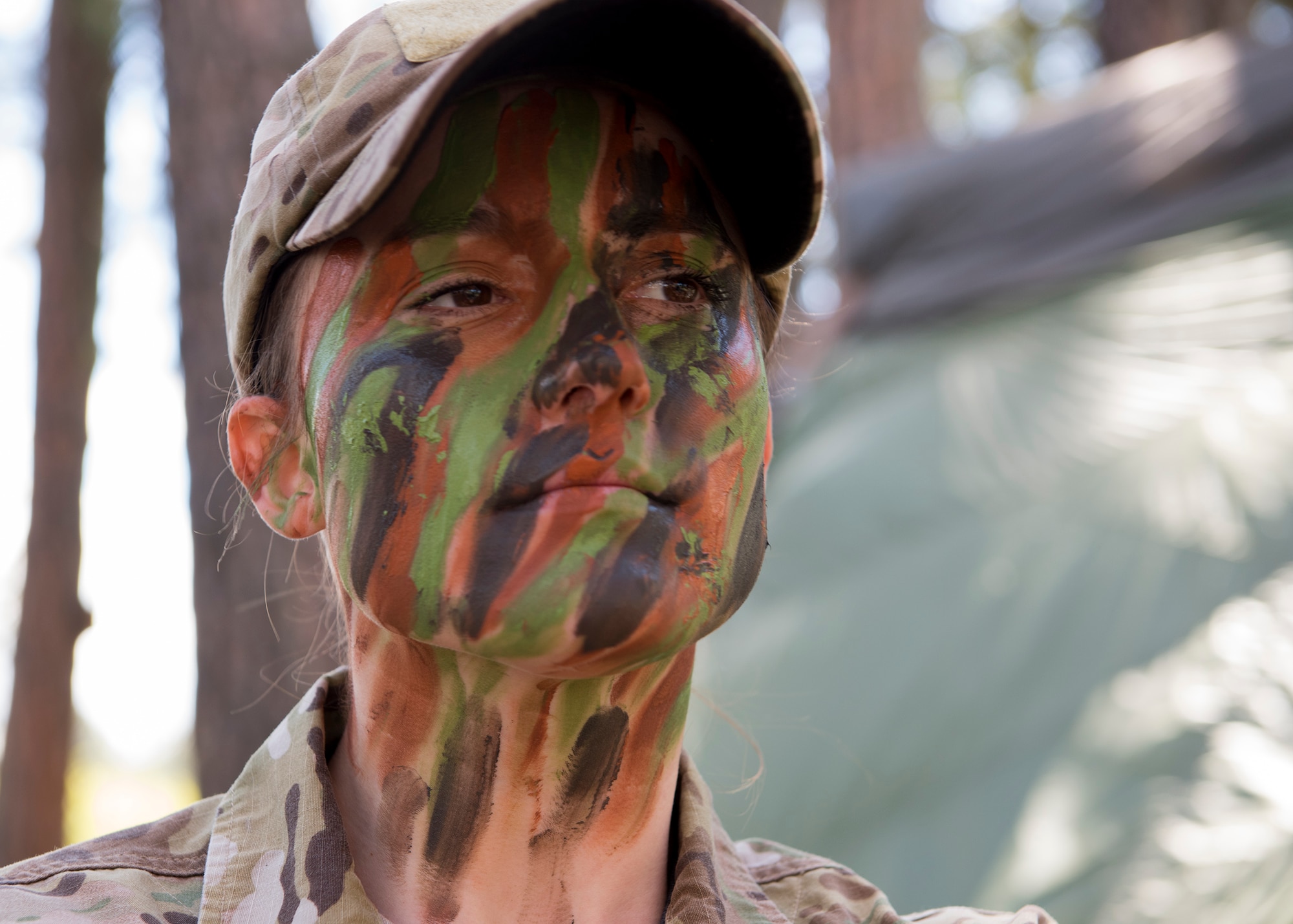 Senior Airman Brittany Wilson, 22nd Training Group survival specialist, displays face paint camouflage Apr. 28, 2017, at Fairchild Air Force Base, Washington. Avoiding detection and moving while camouflaged is a critical part of the evasion portion of survival training. (U.S. Air Force Photo / Airman 1st Class Ryan Lackey)