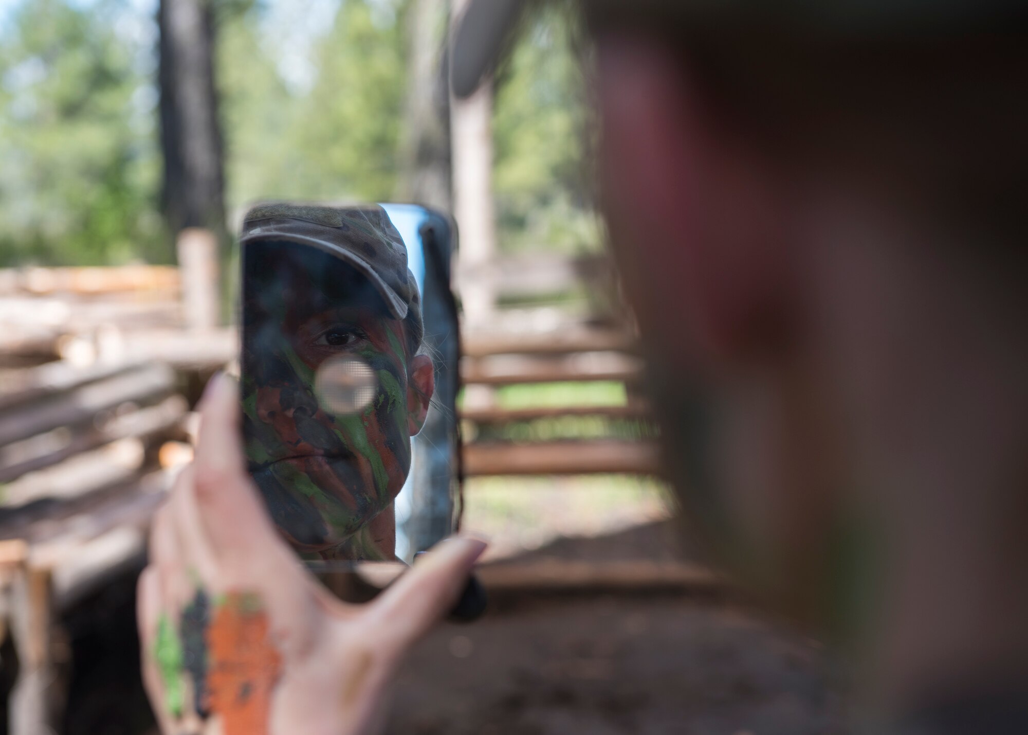 Senior Airman Brittany Wilson, 22nd Training Group survival specialist, applies face paints Apr. 28, 2017, at Fairchild Air Force Base, Washington. Using what is available to make the most of your situation is a vital part of survival and avoiding detection. (U.S. Air Force Photo / Airman 1st Class Ryan Lackey)