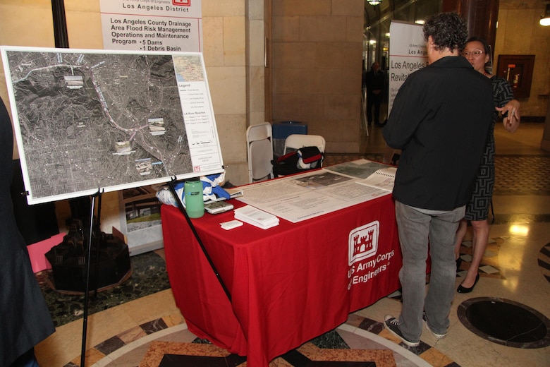 Eileen Takata, a public involvment specialist, with the U.S. Army Corps of Engineers Los Angeles District talks with vistors at the District's information table. Members of the  District joined City of Los Angeles Councilmember Mitch O’Farrell and his staff in recognizing the collaborative efforts to improve, preserve and revitalize the Los Angeles River during a special City Council presentation City Hall June 8.