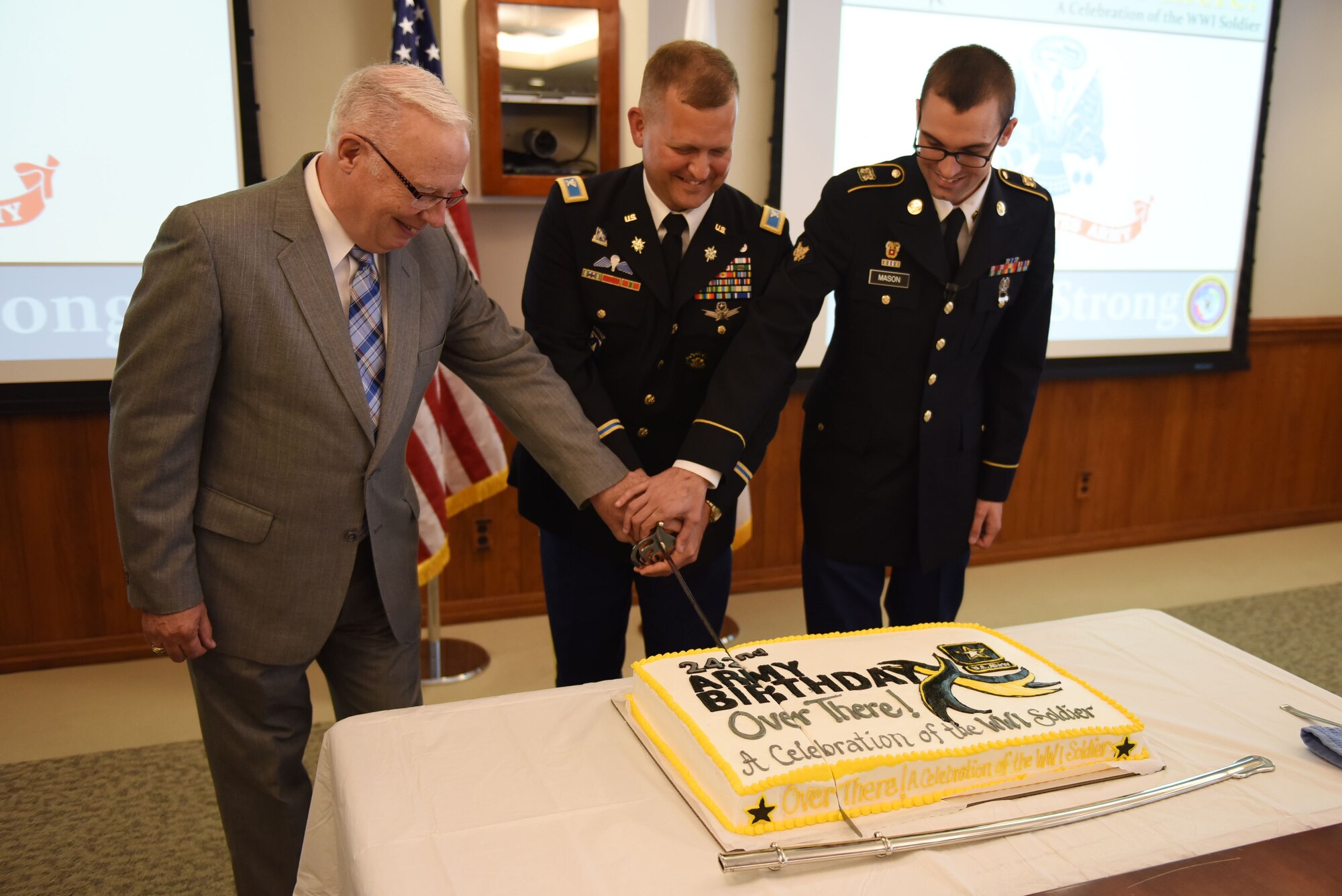 Retired Army Col. Geoff Moran, Army Col. Brian Moore, Joint Functional Component Command for Space director of operations and exercises, and Army Spc. Alan Mason, Joint Space Operations Center defensive duty technician, cut a birthday cake for the Army’s 242nd birthday, June 14, 2017, Vandenberg Air Force Base, Calif. Members from all branches were in attendance to celebrate the impact and contributions of soldiers dating all the way back to 1775. (U.S. Air Force photo by Senior Airman Robert J. Volio/Released)