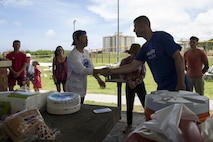 The Mayor of Urasoe City Tetsuji Matsumoto shakes hands with Col. Christopher Feyedelem during a friendship softball game and barbecue June 11 aboard Camp Kinser, Okinawa, Japan. Members of the Japan Ground Self-Defense Force, Urasoe Police Department, City Hall, the mayor of Urasoe and Marines came together for a friendly game of softball followed by an all-American lunch of hotdogs and hamburgers. Feyedelem is the Camp Kinser camp commander and commanding officer of 3rd Marine Logistics Group, Headquarters Regiment.