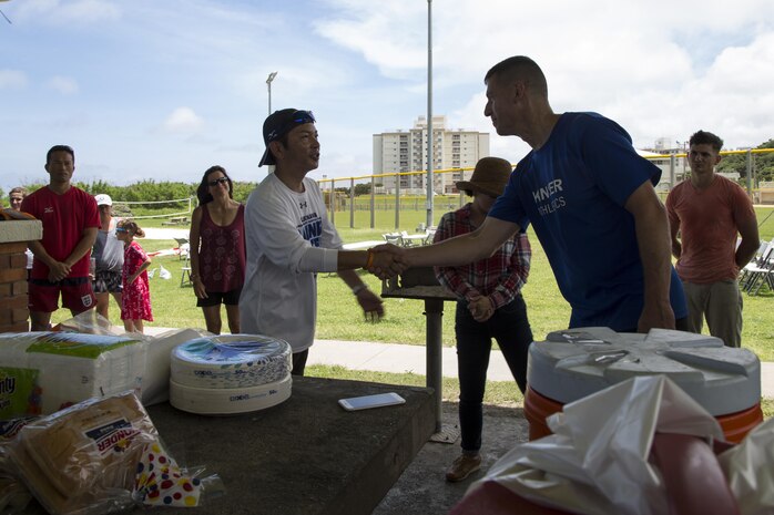 The Mayor of Urasoe City Tetsuji Matsumoto shakes hands with Col. Christopher Feyedelem during a friendship softball game and barbecue June 11 aboard Camp Kinser, Okinawa, Japan. Members of the Japan Ground Self-Defense Force, Urasoe Police Department, City Hall, the mayor of Urasoe and Marines came together for a friendly game of softball followed by an all-American lunch of hotdogs and hamburgers. Feyedelem is the Camp Kinser camp commander and commanding officer of 3rd Marine Logistics Group, Headquarters Regiment.