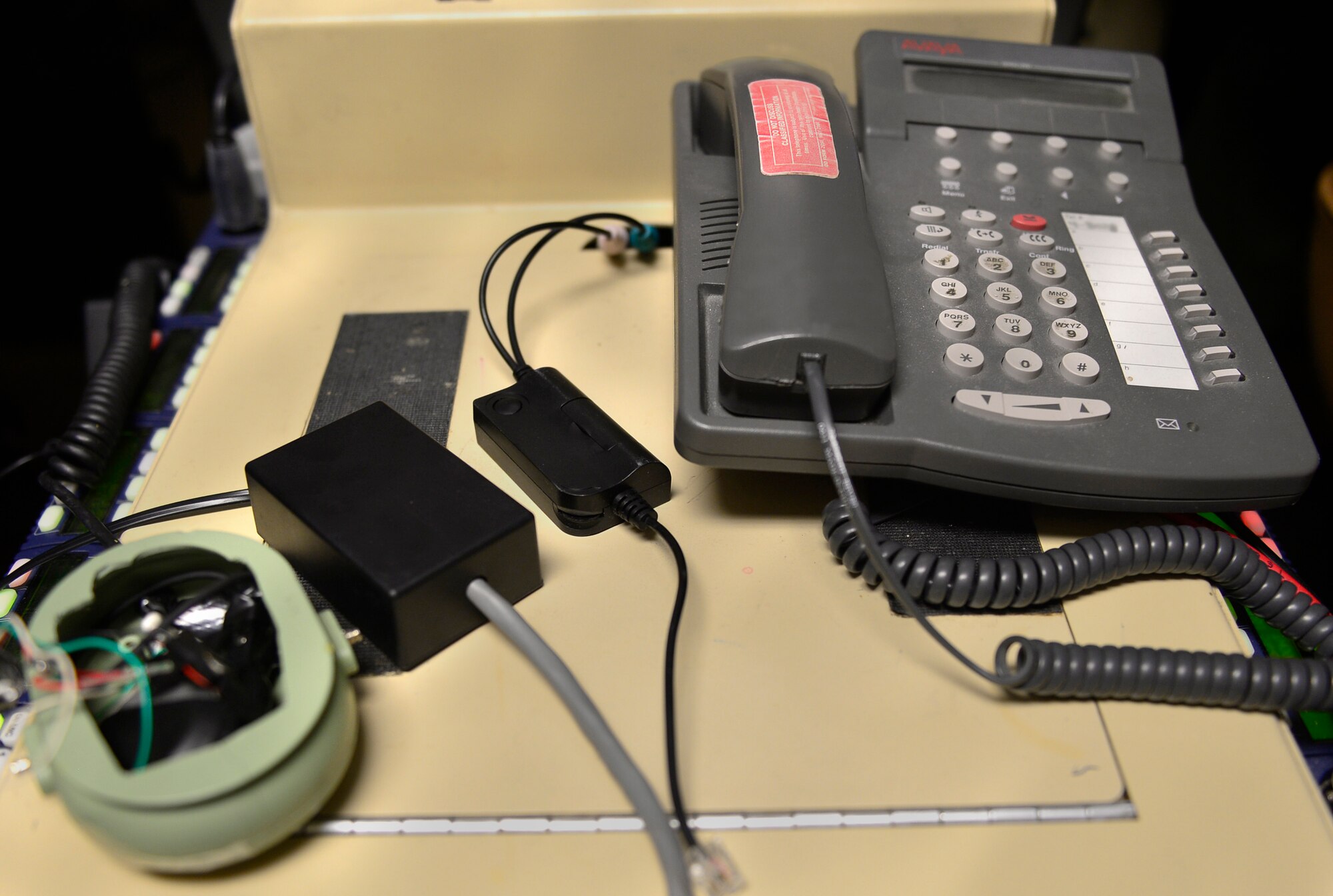 From left to right, the Frankenphone, the Frankenphone 2.0 and the headset connector are displayed June 12, 2017, at Creech Air Force Base, Nev. The Frankenphone has filled a gap for a long term solution to communications deficiencies by routing calls from the joint terminal attack controllers to the telephone and patching it into the aircrew’s headsets. This has allowed MQ-9 aircrews to properly receive weapons strike guidance from the ground forces to take the fight to the enemy. The Frankenphone 2.0 offered improved durability and sound clarity while the headset connector is an evolution of the Frankenphone which is already integrated in the Audio Multi Level System. (U.S. Air Force photo/Senior Airman Christian Clausen)