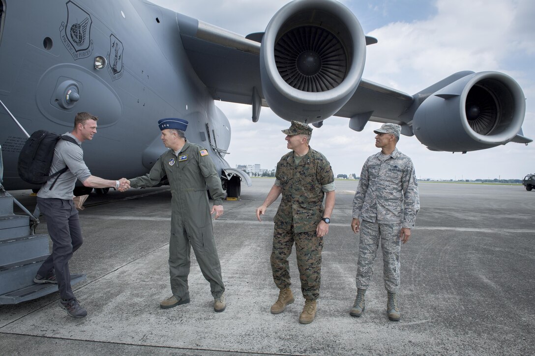 U.S. Air Force Lt. Gen. Jerry P. Martinez, United States Forces Japan and 5th Air Force commander, greets Noncombatant Evacuation Operations exercise participants, June 6, 2017, at Yokota Air Base, Japan. The decision to conduct a NEO is made on a case by case basis due to natural disasters, civil unrest or military conflict to ensure the safety of the estimated 228,000 U.S. citizen residents and tourists in the Republic of Korea. (U.S. Air Force photo by Airman 1st Class Donald Hudson)