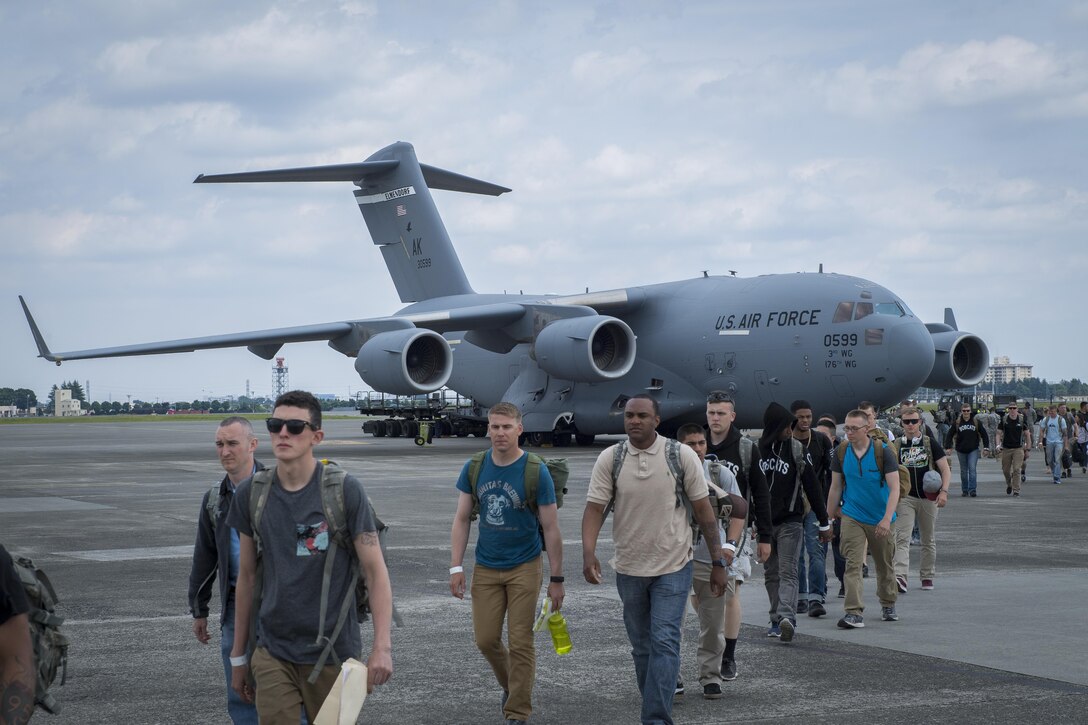 Participates in a Noncombatant Evacuation Operations exercise walk from a C-17 Globe Master to the passenger terminal, June 6, 2017, at Yokota Air Base, Japan. Over 360 active duty, family members and simulated pets participated in the exercise. (U.S. Air Force photo by Airman 1st Class Donald Hudson)