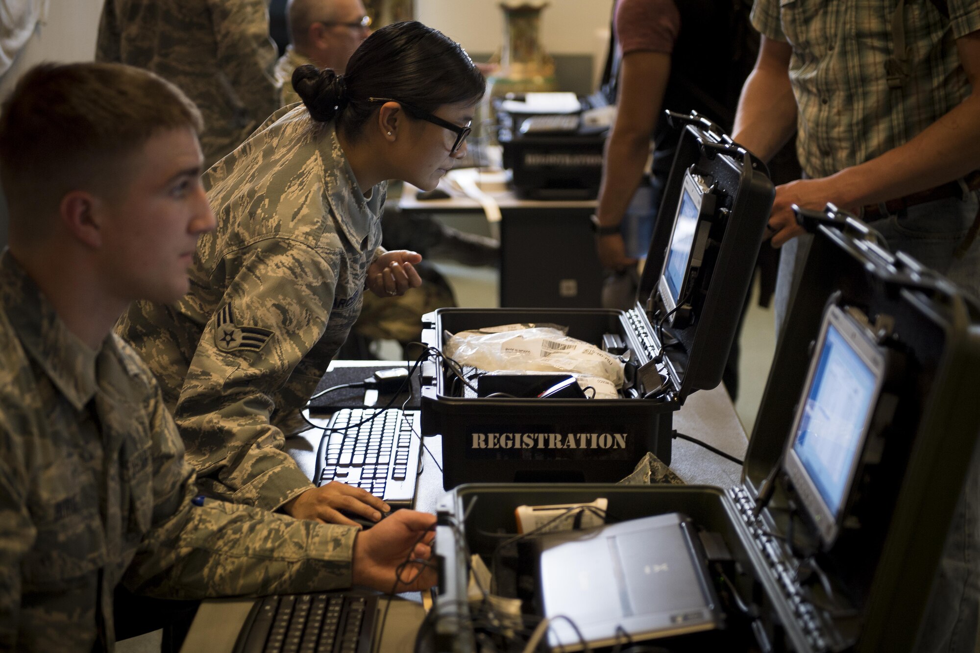 U.S. Air Force Senior Airman Krisevron Arcega, 459th Airlift Squadron NEO tracking system augmentee, checks in NEO exercise participants, June 6, 2017, at Yokota Air Base, Japan. Over 360 active duty, family members and simulated pets participated in the exercise. (U.S. Air Force photo by Airman 1st Class Donald Hudson)
