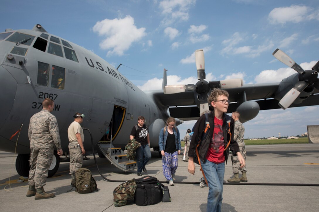 Family members representing installations and commands throughout the Korean Peninsula exist a U.S. Air Force C-130 Hercules at Yokota Air Base, Japan, June 6, 2017 for noncombatant evacuation exercise Focused Passage 2017. The exercise takes place at US military installations throughout the Korean Peninsula and is designed to ensure service members are prepared to evacuate designated noncombatants. (U.S. Air Force photo by Yasuo Osakabe)