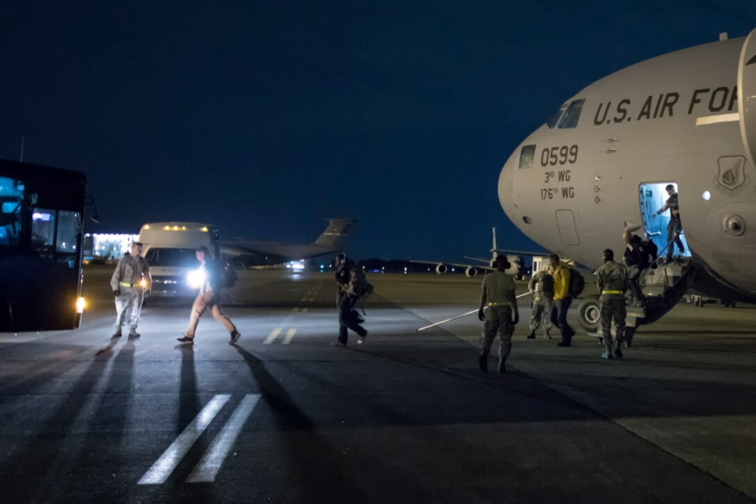 U.S. Army Solders get off a C-17 Globemaster III at Yokota Air Base, Japan, June 6, 2017, during exercise Focused Passage 2017. Eighth Army conducts Noncombatant Evacuation Operations administrative and training tasks designed to inspect NEO packets, conduct NEO representative/warden training, NEO tracking system (NTS) operator training, and account for all Department of Defense noncombatants. (U.S. Air Force photo by Yasuo Osakabe)
