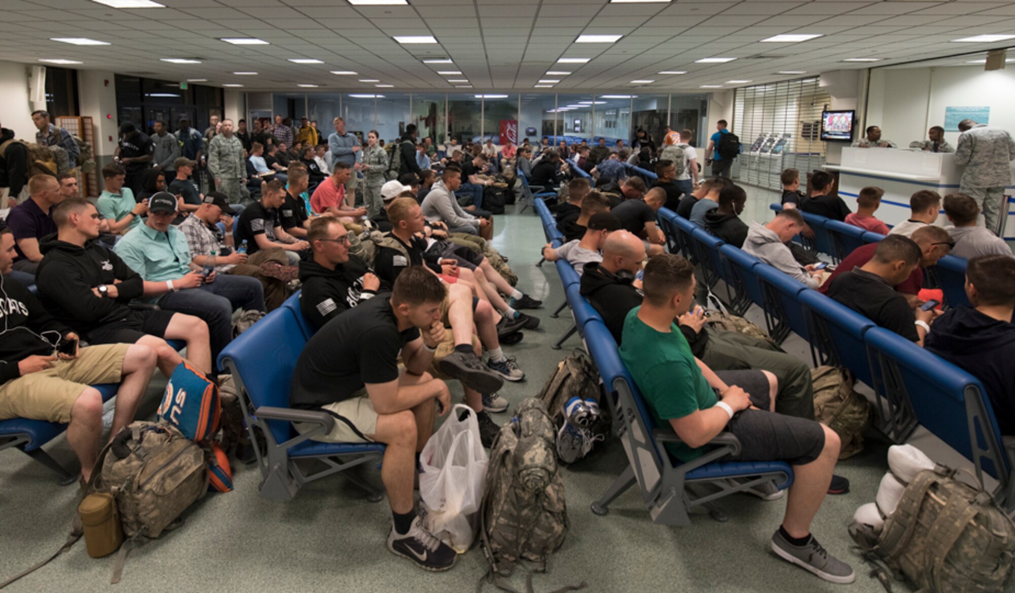 U.S. Army Solders get a briefing from a Yokota passenger serviceman at Yokota Air Base, Japan, June 6, 2017, during exercise Focused Passage 2017. FP 2017 is designed to ensure Eighth Army service members and families are prepared to evacuate during a crisis situation. During the exercise, noncombatant evacuees are required to have their NEO packets checked by their unit NEO warden. (U.S. Air Force photo by Yasuo Osakabe)