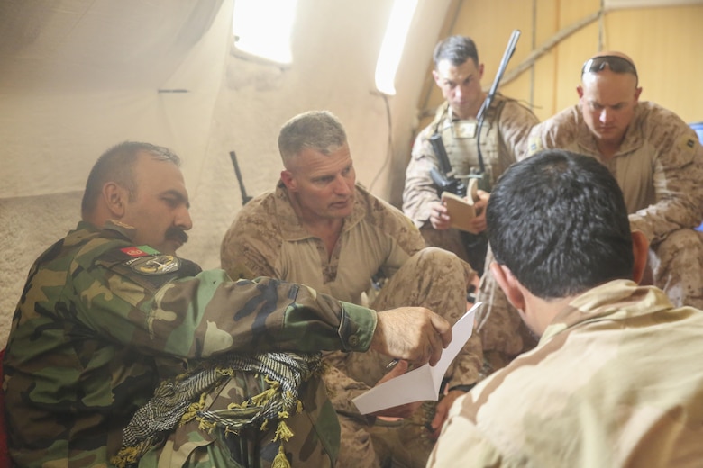 Afghan National Army Brig. Gen. Ahmadzai, left, the commanding general of the 215th Corps, and U.S. Marine Brig. Gen. Roger Turner, center, the commanding general of Task Force Southwest, discuss offensive strategy during an advisory meeting at Camp Hanson, Afghanistan, June 13, 2017. The 1st and 3rd Brigades of the 215th Corps recently commenced offensive operations in Nad-e Ali and Marjah in order to impede insurgency activities. Marines and Sailors from Task Force Southwest are supporting their Afghan counterparts as part of the Task Force’s role as the main advisory element in Helmand Province. (U.S. Marine Corps photo by Sgt. Lucas Hopkins)