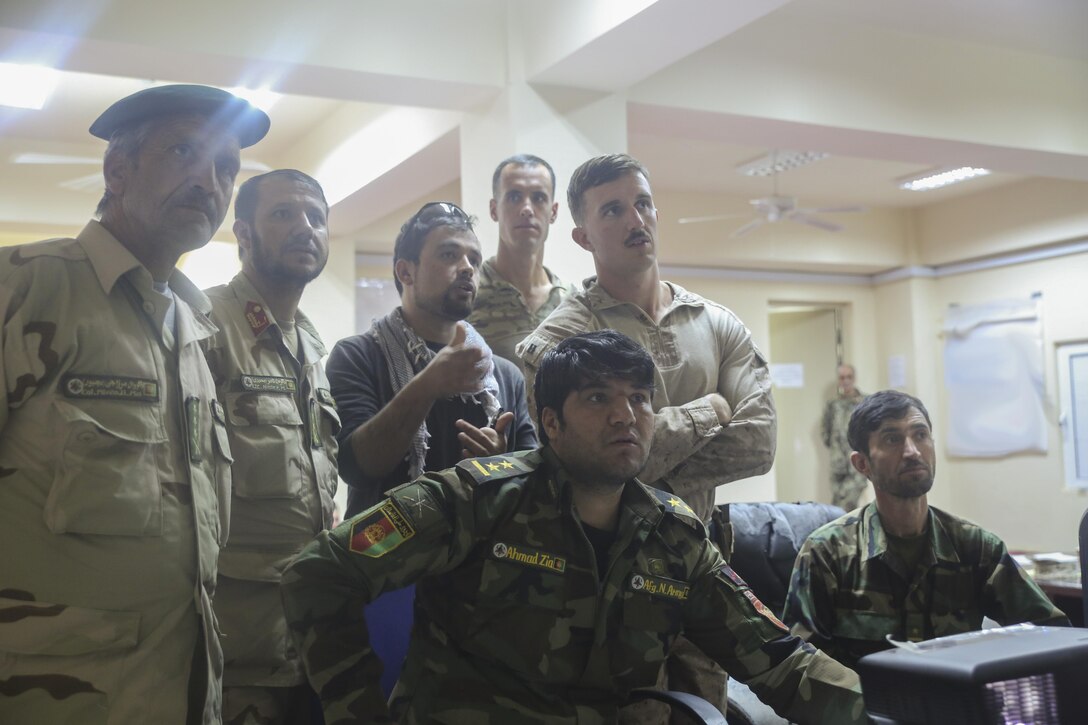 U.S. Marine and Navy Sailor advisors with Task Force Southwest and Afghan National Army soldiers with the 215th Corps monitor offensive operations with intelligence assets at Camp Shorabak, Afghanistan, June 14, 2017. Marines and Sailors from Task Force Southwest are advising  and assisting the 1st and 3rd Brigades of the 215th Corps during Operation Maiwand Three, which is designed to clear Nad-e Ali and Marjah of insurgents. (U.S. Marine Corps photo by Sgt. Lucas Hopkins)