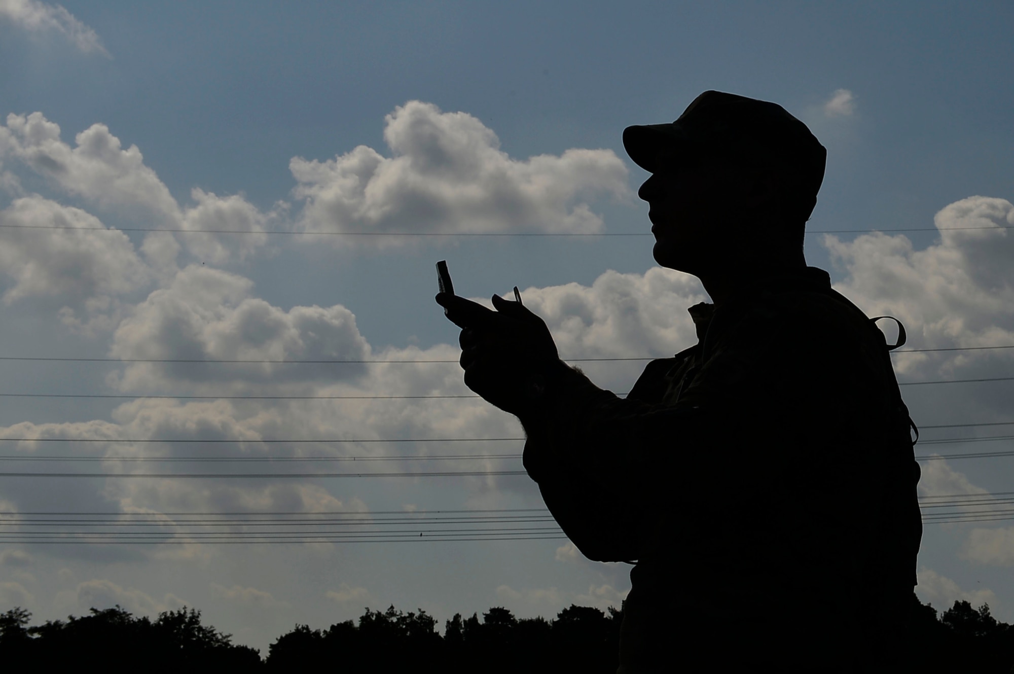 U.S. Air Force Airman 1st Class Athon Arant, 7th Weather Squadron detachment 4 weather apprentice, uses a compass to navigate at the Mainz Sand Dunes, Germany, June 13, 2017. Army weather support Airmen are required to attain certification in certain soldier skills which help them enhance their capabilities to work with the U.S. Army. (U.S. Air Force photo by Airman 1st Class Joshua Magbanua)