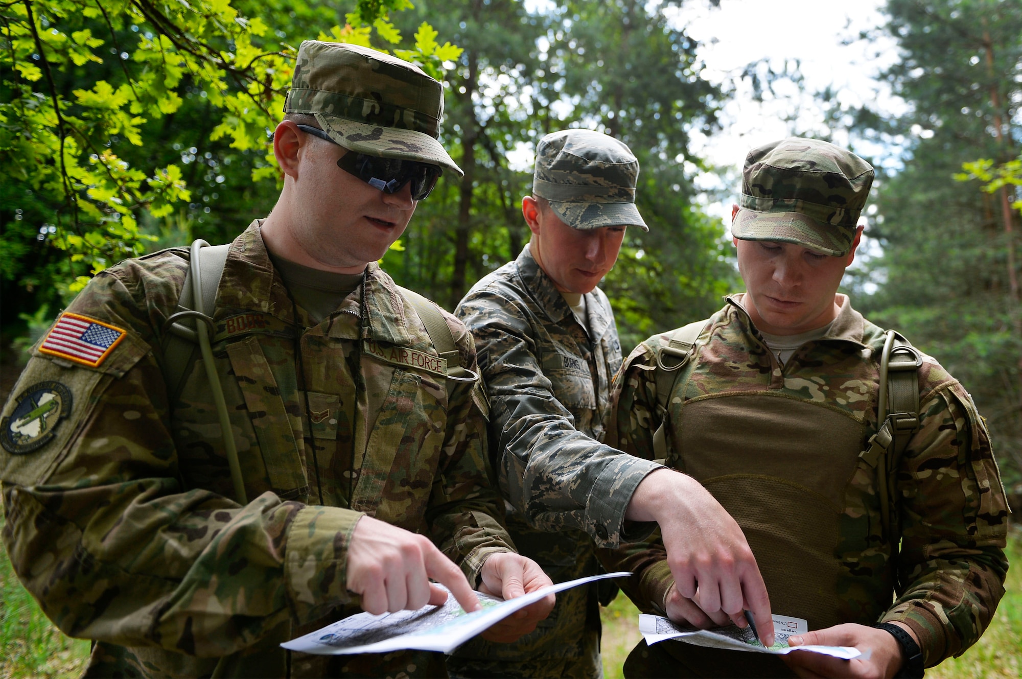 U.S. Airmen from the 7th Weather Squadron conduct land navigation at the Mainz Sand Dunes, Germany, June 13, 2017. Airmen of the 7th WS use Exercise Cadre Focus to help enhance their capability to cooperate with the U.S. Army. (U.S. Air Force photo by Airman 1st Class Joshua Magbanua)